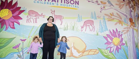 Patients standing at the entrance mural to Jim Pattison Children's Hospital.